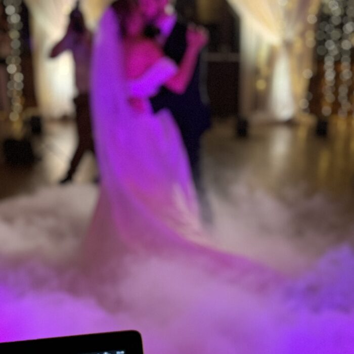 Soft focus view of a dreamy dancefloor with a bride and her groom dancing