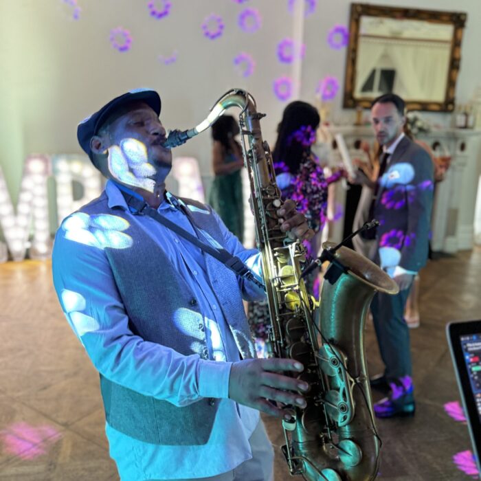 A Saxophone player under disco lights