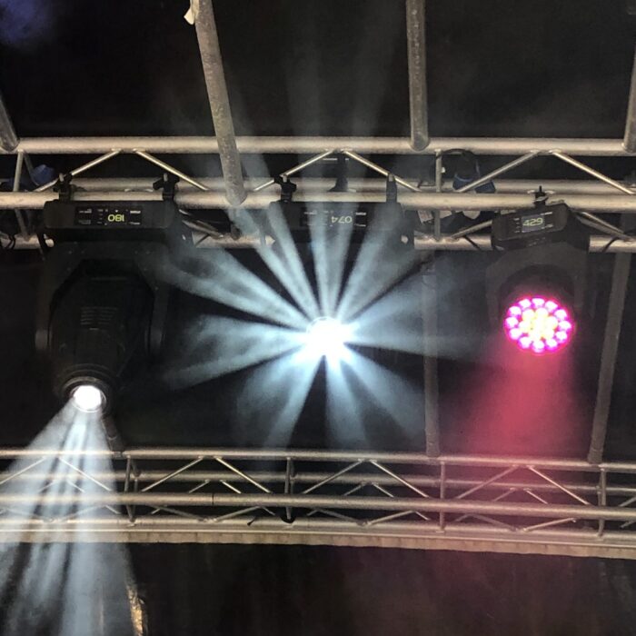 Stage Lights shine down from a gantry